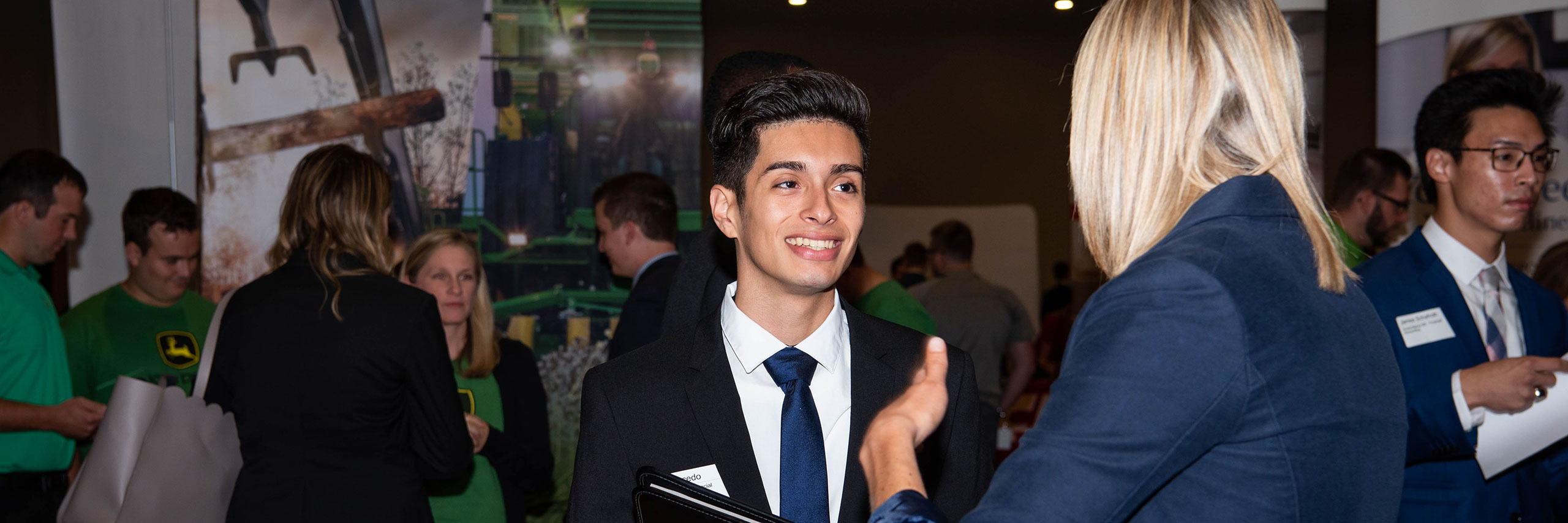 Student talking with a professional in a career fair