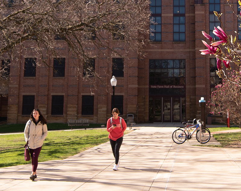 Students walking in front of State Farm Hall of Business building