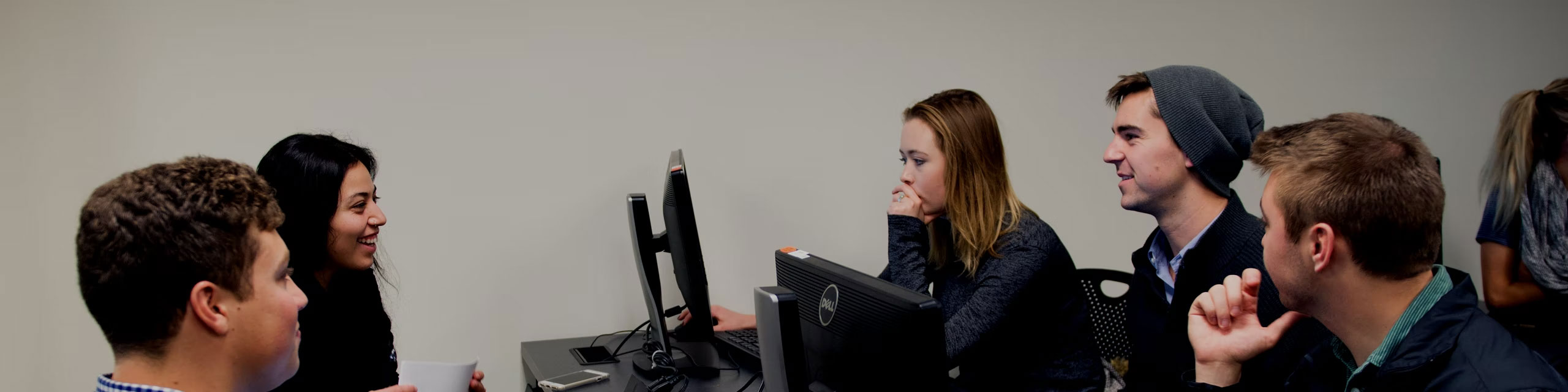 Group of students talking in a classroom