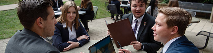 Students talking at State Farm Hall of Business courtyard.